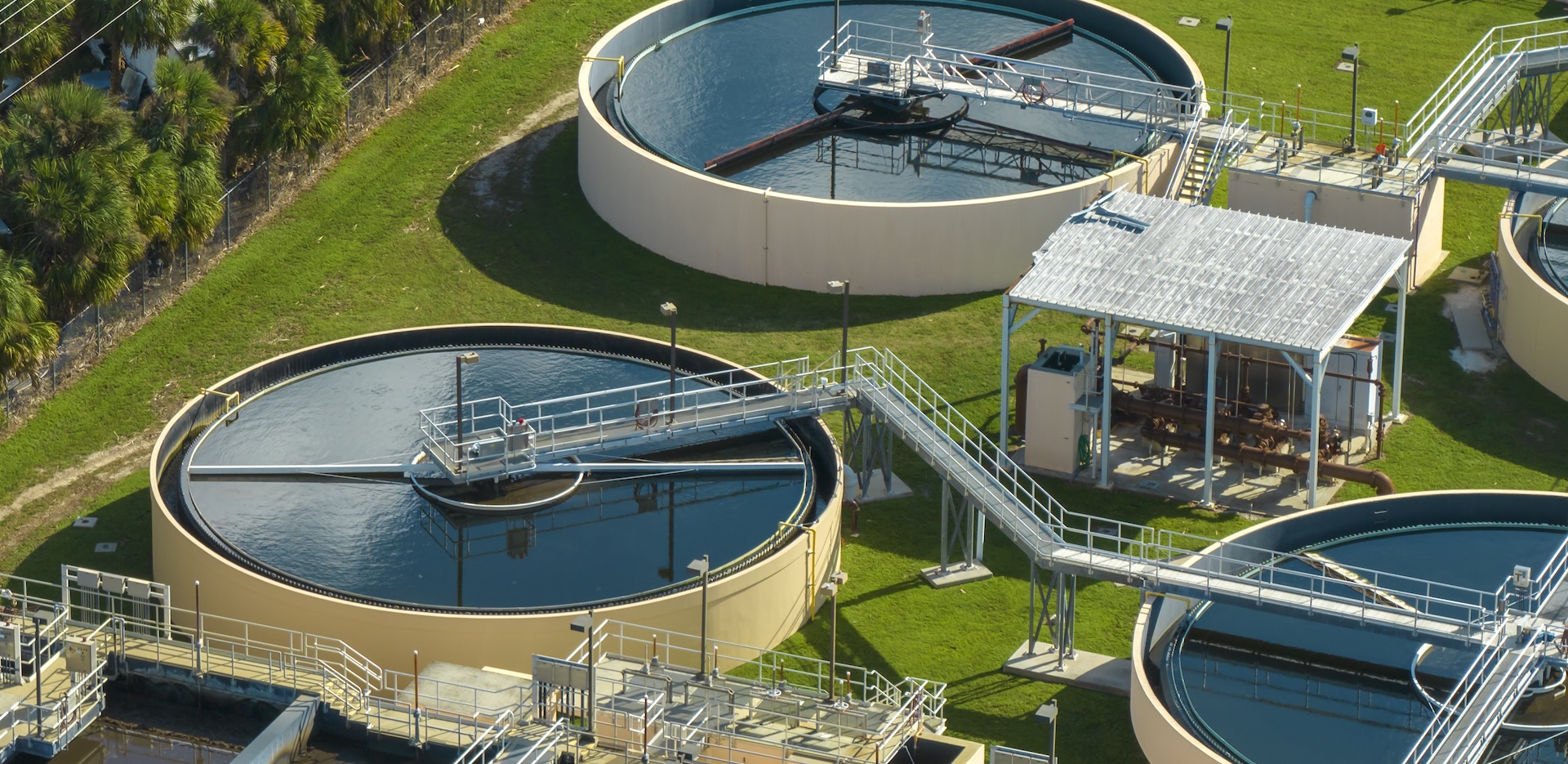 Aerial view of modern water cleaning facility at urban wastewater treatment plant. Purification process of removing undesirable chemicals, suspended solids and gases from contaminated liquid.